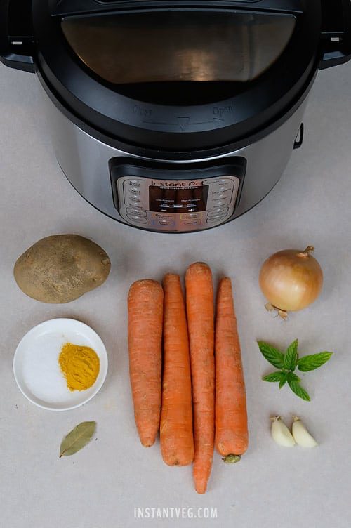 Ingredients used to make Instant Pot Vegan Carrot Soup - Carrots, Potato, Onion, Garlic, Salt, Turmeric, Bay Leaf, and Mint.