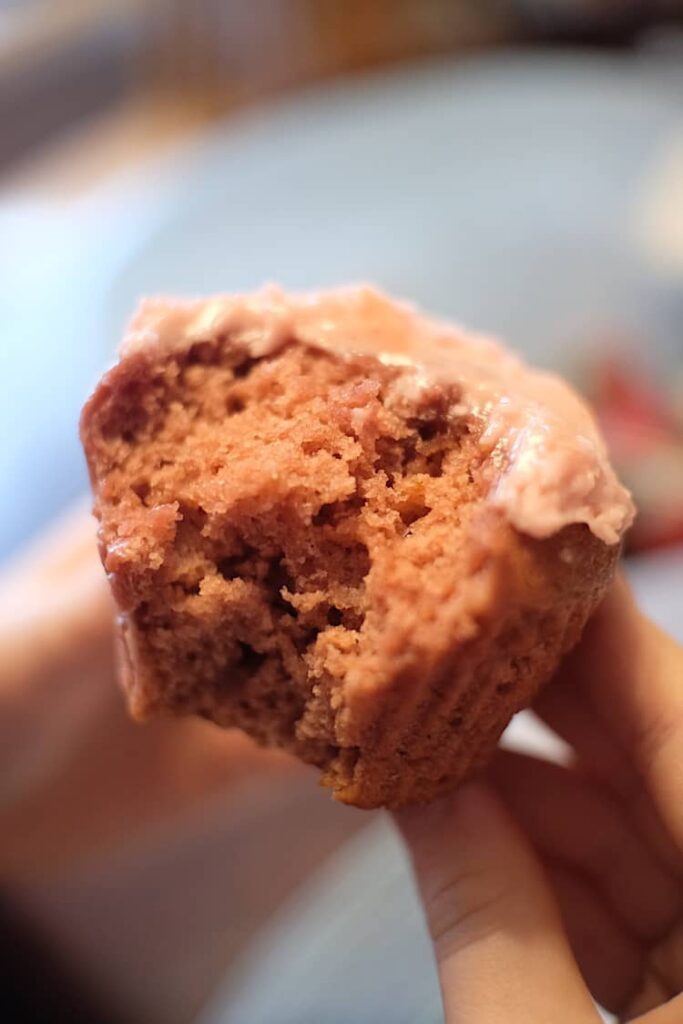 Vegan strawberry cupcake with strawberry cupcake, with a bite taken