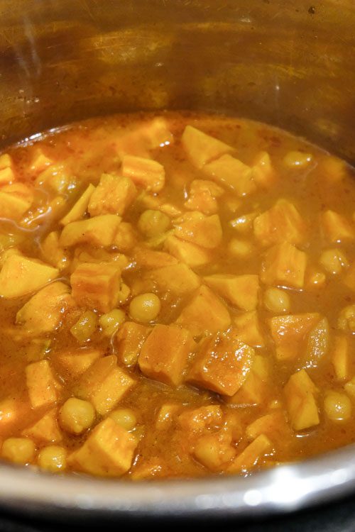 Flavorful chickpea curry with fluffy white rice. This recipe uses the pot-in-pot technique to cook the curry and rice simultaneously in the Instant Pot. #vegancurry #veganindianfood #veganinstantpot #vegandinners #vegansweetpotatocurry #veganrecipes #vegcurry #easyveganrecipes #quickveganrecipes #healthyveganrecipes #vegan