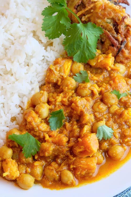 Flavorful chickpea curry with fluffy white rice. This recipe uses the pot-in-pot technique to cook the curry and rice simultaneously in the Instant Pot. #vegancurry #veganindianfood #veganinstantpot #vegandinners #vegansweetpotatocurry #veganrecipes #vegcurry #easyveganrecipes #quickveganrecipes #healthyveganrecipes #vegan