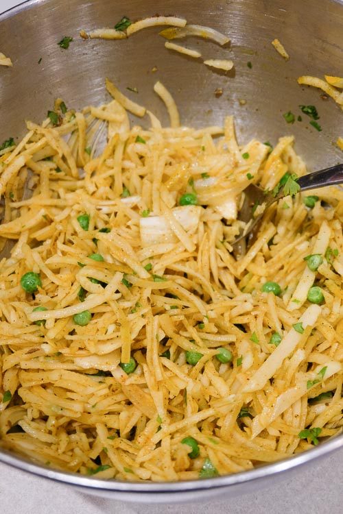 All the pakora ingredients in a bowl, after being mixed together.