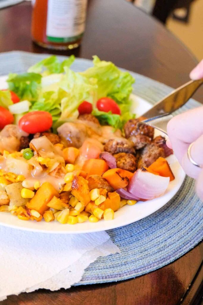 Vegetable roast on a plate with salad and vegan gravy.