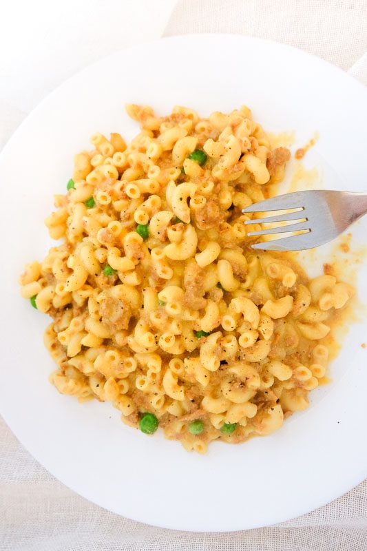 easy vegan instant pot mac and cheese made with carrots and soy crumbles and peas, it tastes like vegan hamburger helper.