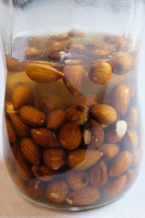 Almonds being soaked in a jar.