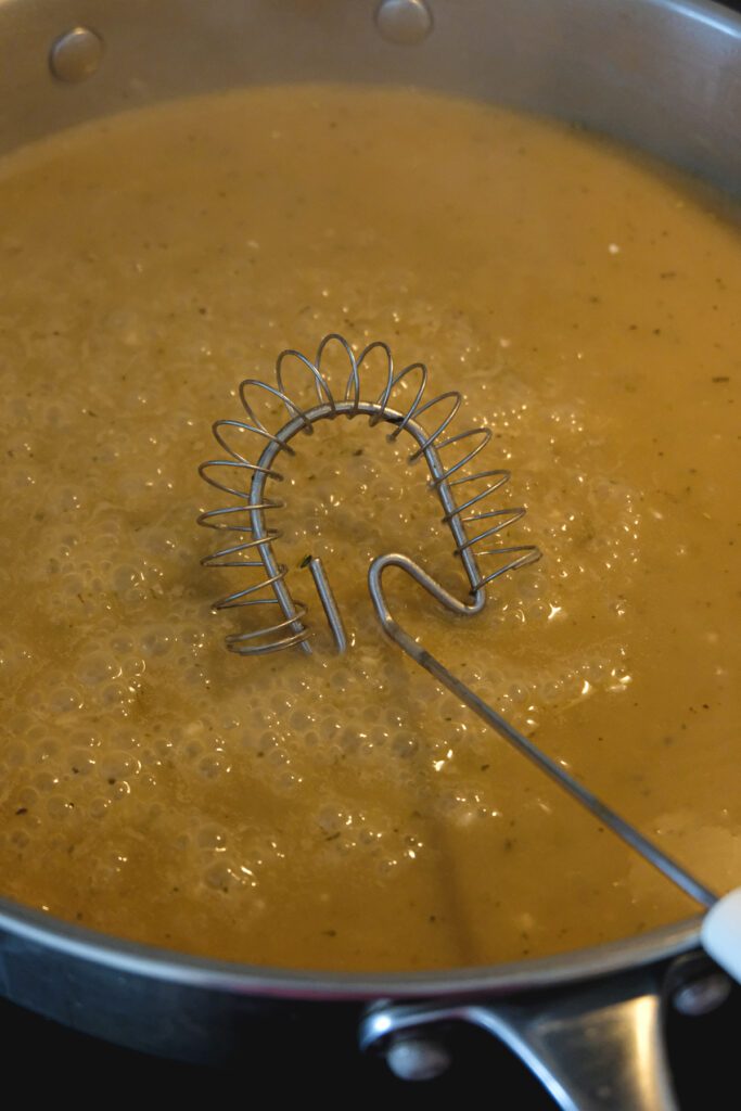 Finished vegan gravy thickening up in a pan.