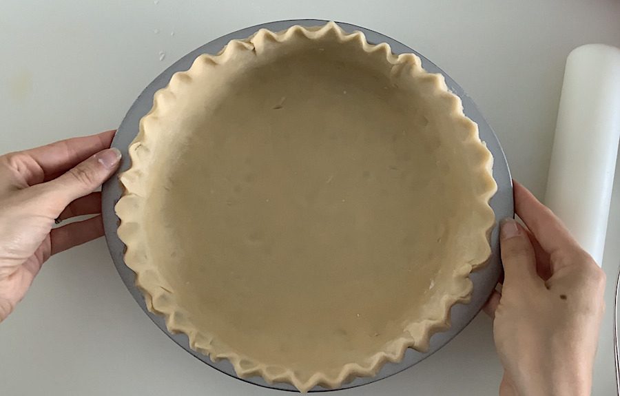 An uncooked pie crust formed into a pan.